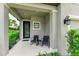 Front porch with two wicker chairs and a small table at 8250 Velda Trl, Sarasota, FL 34241