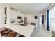 Modern kitchen with white cabinets, large island, and stainless steel appliances at 8250 Velda Trl, Sarasota, FL 34241