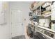 Laundry room with washer, dryer, and storage shelves at 8250 Velda Trl, Sarasota, FL 34241