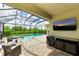 Screened pool and patio with outdoor TV at 8250 Velda Trl, Sarasota, FL 34241