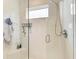 Clean shower with glass enclosure, built-in shelving, and bench at 8250 Velda Trl, Sarasota, FL 34241