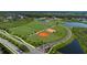 Aerial view of community sports fields including a soccer field and baseball diamonds, perfect for outdoor activities at 8250 Velda Trl, Sarasota, FL 34241