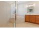 Bathroom with corner shower, garden tub, and wood cabinets at 8368 Miramar Way # 21, Lakewood Ranch, FL 34202