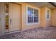 Front entrance with a light beige door, large window, and brick flooring at 8368 Miramar Way # 21, Lakewood Ranch, FL 34202