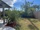 Large backyard with grassy area and mature plants at 8585 Cristobal Avenue, North Port, FL 34287