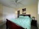 Bedroom with queen bed, dark wood furniture, and ceiling fan at 8585 Cristobal Avenue, North Port, FL 34287