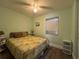 Spacious bedroom with a queen bed and ceiling fan at 8585 Cristobal Avenue, North Port, FL 34287