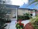 House entrance with red flowers and walkway at 8585 Cristobal Avenue, North Port, FL 34287