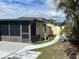 Home's exterior showcasing a walkway and screened porch at 8585 Cristobal Avenue, North Port, FL 34287