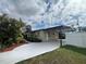 Tan house with carport and landscaped yard at 8585 Cristobal Avenue, North Port, FL 34287