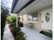 House entrance with a bench and potted plants at 8585 Cristobal Avenue, North Port, FL 34287