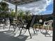 Relaxing patio seating area with table and chairs under a pergola at 8585 Cristobal Avenue, North Port, FL 34287