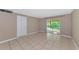 Bedroom with tiled floors and sliding glass doors at 936 La Costa Cir # 4, Sarasota, FL 34237