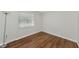 Simple bedroom with wood-look floors and window at 936 La Costa Cir # 4, Sarasota, FL 34237