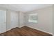 Well-lit bedroom with wood-look floors and window at 936 La Costa Cir # 4, Sarasota, FL 34237