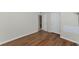 Bedroom with wood-look floors and access to another room at 936 La Costa Cir # 4, Sarasota, FL 34237