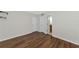 Bedroom with wood-look floors and access to bathroom at 936 La Costa Cir # 4, Sarasota, FL 34237