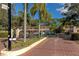 Gated community entrance with brick pavers and lush landscaping at 936 La Costa Cir # 4, Sarasota, FL 34237