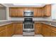 Kitchen with wood cabinets and stainless steel appliances at 936 La Costa Cir # 4, Sarasota, FL 34237