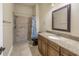 This stylish bathroom has a granite vanity and a shower with tan tile at 9709 Wilderness Trl, Weeki Wachee, FL 34613