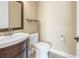 Bathroom featuring a toilet, vanity and mirror at 9709 Wilderness Trl, Weeki Wachee, FL 34613