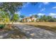 Paver driveway leading to a beautiful home with lush landscaping at 9709 Wilderness Trl, Weeki Wachee, FL 34613