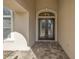 Close-up of a beautiful double-door front entrance with sidelights and transom window at 9709 Wilderness Trl, Weeki Wachee, FL 34613