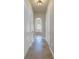 Hallway with tiled floor that looks into the main bathroom that has a sunken tub at 9709 Wilderness Trl, Weeki Wachee, FL 34613