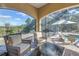 Outdoor seating with a table and chair overlooking the screened-in pool at 9709 Wilderness Trl, Weeki Wachee, FL 34613