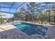 Relax by the screened-in pool with ample lounge space and lush greenery at 9709 Wilderness Trl, Weeki Wachee, FL 34613