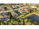 Aerial view of homes and pond, showing the community's landscape at 5341 Greenbrook Dr, Sarasota, FL 34238