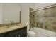 Bathroom with granite countertop, tub shower combo, and modern fixtures at 5341 Greenbrook Dr, Sarasota, FL 34238