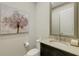 Powder room with granite countertop, decorative mirror, and dark cabinetry at 5341 Greenbrook Dr, Sarasota, FL 34238