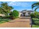 Elegant home with paver driveway, landscaping, and two-car garage at 5341 Greenbrook Dr, Sarasota, FL 34238