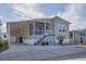 Exterior of a move-in ready manufactured home with covered carport at 10315 Cortez W Rd # 5H, Bradenton, FL 34210