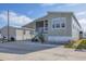 Attractive manufactured home exterior with covered porch and landscaping at 10315 Cortez W Rd # 5H, Bradenton, FL 34210