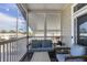 Screened porch with wicker furniture, offering a relaxing outdoor space at 10315 Cortez W Rd # 5H, Bradenton, FL 34210
