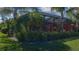 Neatly landscaped backyard with tropical plants and lush greenery at 10624 Falling Leaf Ct, Parrish, FL 34219