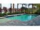 Inviting pool area with screened enclosure, water features, and ample patio space at 10624 Falling Leaf Ct, Parrish, FL 34219