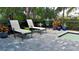 Relaxing poolside patio with lounge chairs and lush tropical landscaping at 10624 Falling Leaf Ct, Parrish, FL 34219