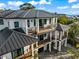 Modern coastal home with multiple balconies and a metal roof at 107 Maple Ave, Anna Maria, FL 34216