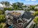 Modern home with rooftop deck, showcasing architectural details at 107 Maple Ave, Anna Maria, FL 34216