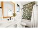 Modern bathroom with a patterned tile shower and a white vanity at 107 Maple Ave, Anna Maria, FL 34216