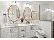 Modern bathroom with double vanity, large mirrors, and a walk-in shower at 107 Maple Ave, Anna Maria, FL 34216