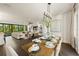 Bright dining room with wooden table and access to the living room at 107 Maple Ave, Anna Maria, FL 34216