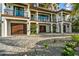 Modern home exterior with paver driveway and tropical landscaping at 107 Maple Ave, Anna Maria, FL 34216