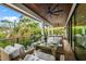 Relaxing outdoor deck with seating area and tropical views at 107 Maple Ave, Anna Maria, FL 34216