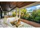 Relaxing outdoor deck with seating area, wood flooring and ceiling at 107 Maple Ave, Anna Maria, FL 34216