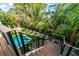 Deck stairs leading to a refreshing pool and lounge area at 107 Maple Ave, Anna Maria, FL 34216