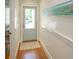 Light and airy entryway with hardwood floors and a light blue door at 110 46Th St, Holmes Beach, FL 34217